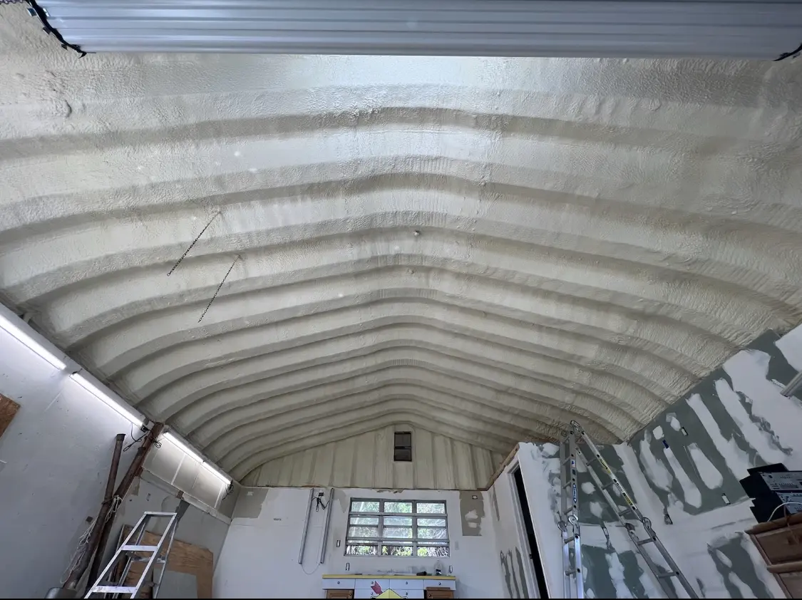 Spray polyurethane foam applied to the underside of a metal roof deck in Clemson University